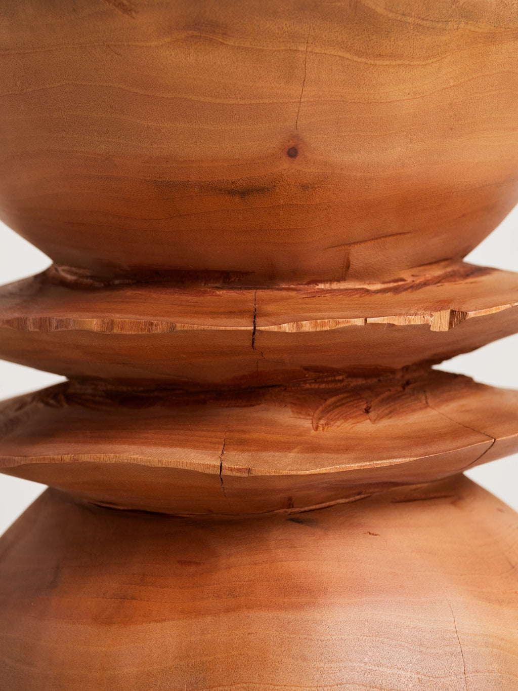 Heaps & Woods Caro Stool, a sculptural solid wood stool crafted from rich natural wood with warm brown tones and visible grain.