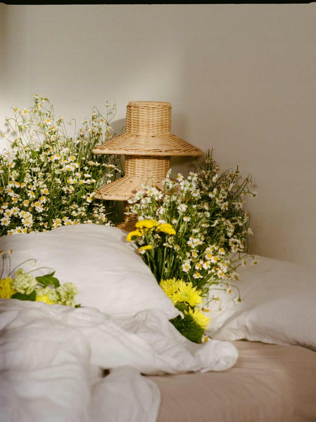 Heaps & Woods Rose Table Lamp, a natural light brown woven rattan table lamp featuring a distinctive tiered pagoda-style shade and a cylindrical base, showcasing beautiful handcrafted texture. This organic modern accent lamp is perfect for a coastal bedroom, bohemian living room, or Japandi-inspired bedside table.