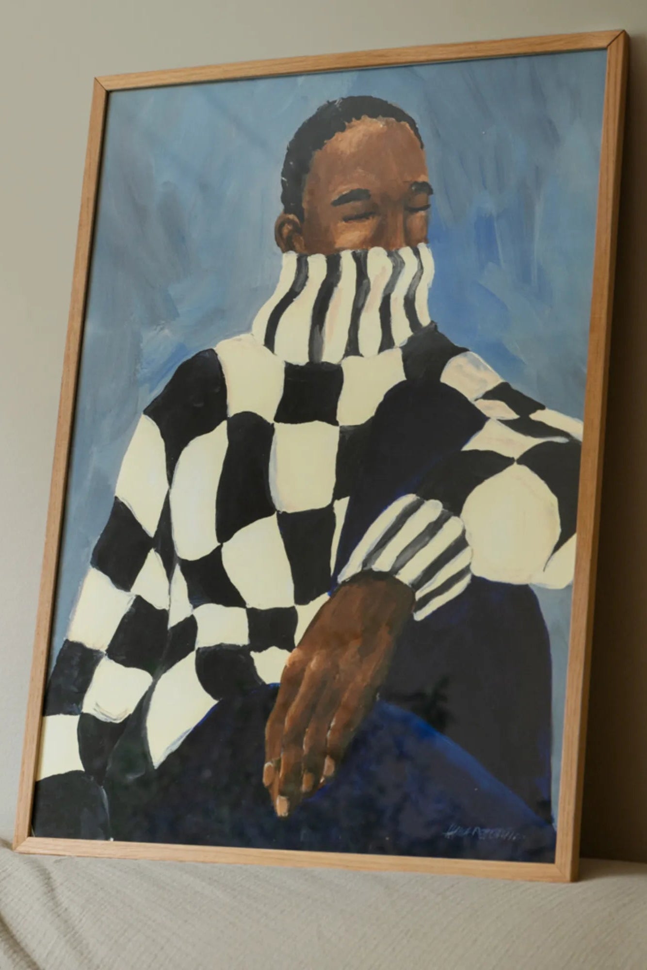 Black and white checkered patterned ceramic mug with handle and matching saucer