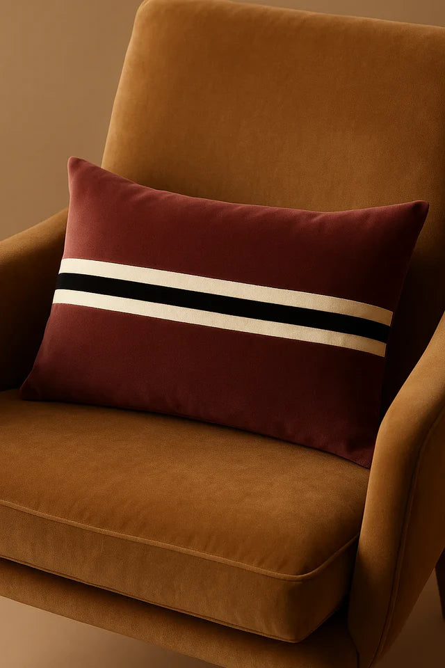 Brown cushion with striped pattern on a brown chair against a beige wall