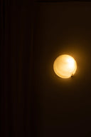 Light bulb emitting a warm glow against a dark background