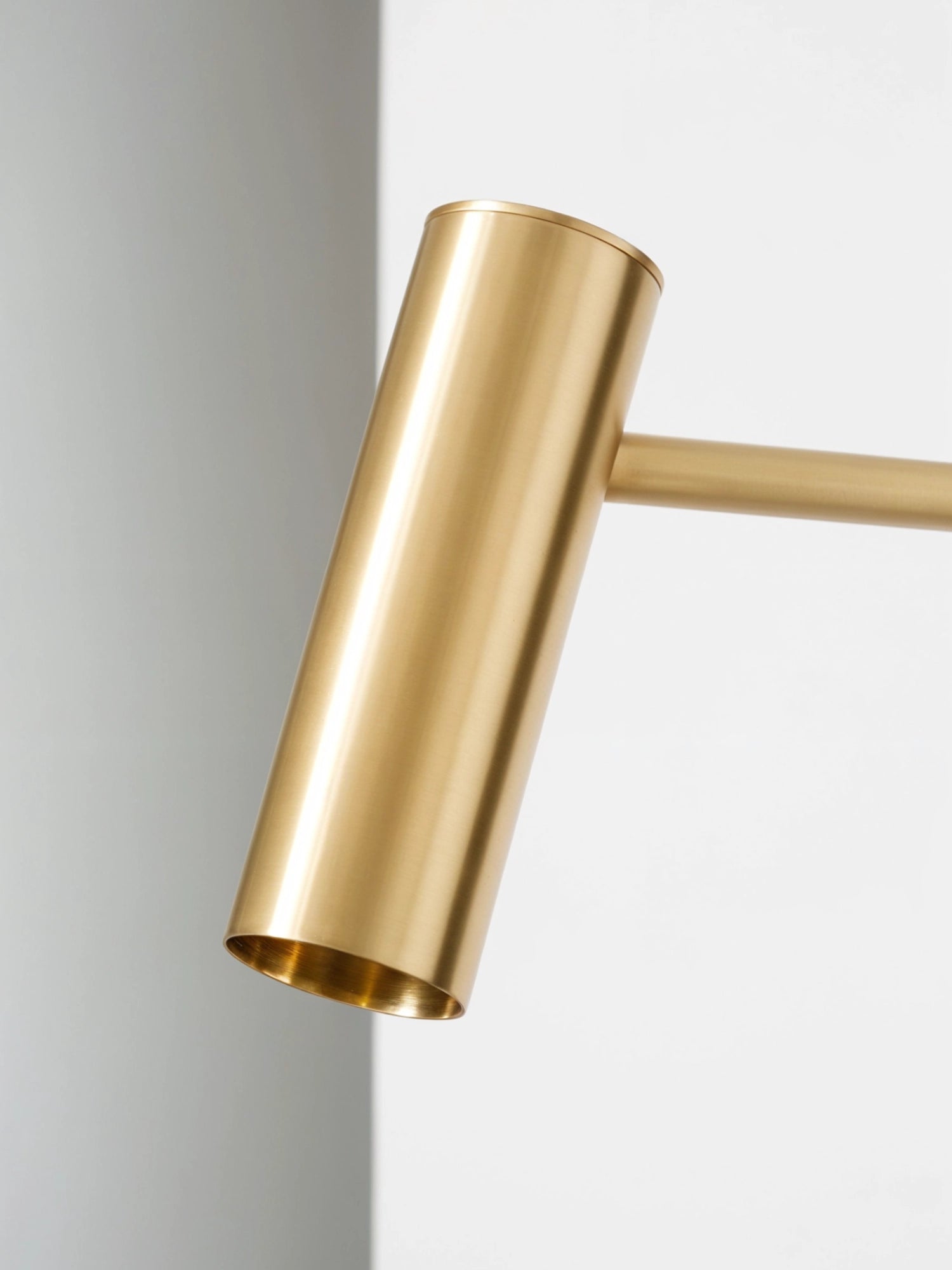 CTO Lighting Heron Floor Lamp, a detailed close-up of the lamp's elegant brass cylindrical head, highlighting the premium material and precise craftsmanship of the design.