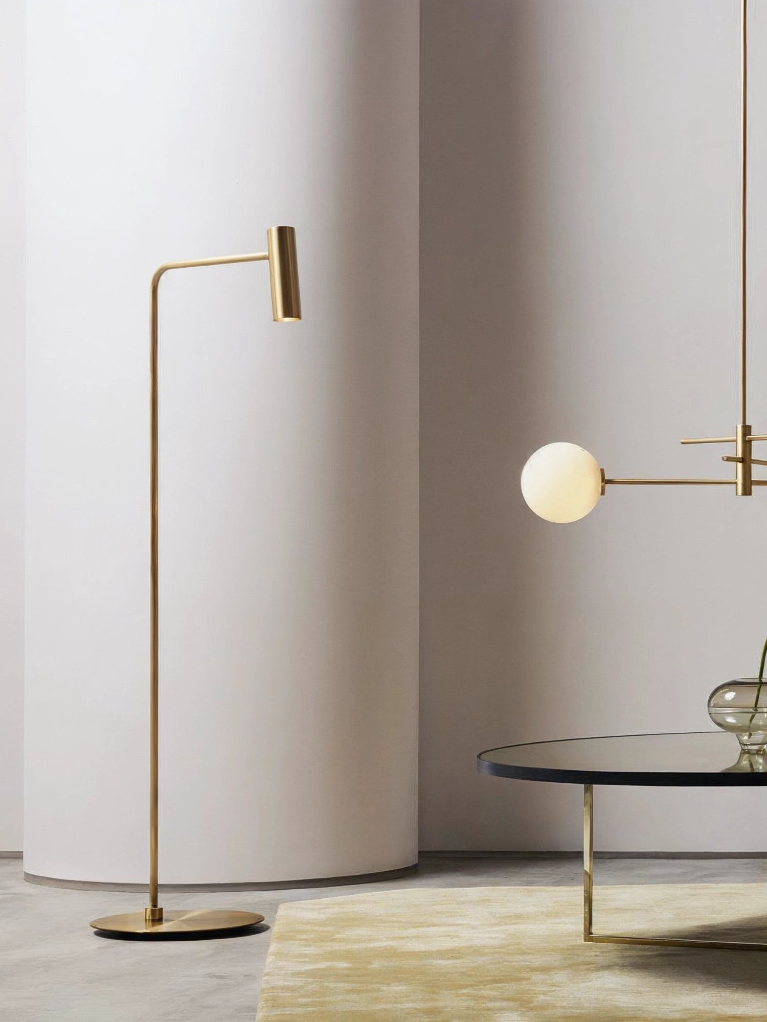 CTO Lighting Heron Floor Lamp, an exquisite brass floor lamp with a sleek, minimalist design and a directional cylindrical light source, complementing a modern interior setting.