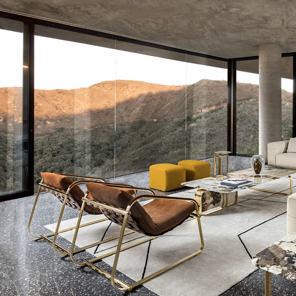 Hessentia Marilyn Pouf, a vibrant mustard yellow upholstered fabric pouf featuring a soft, subtly textured finish and a clean cube shape. This modern minimalist design offers versatile extra seating or a stylish footrest. Perfect for contemporary living rooms or as a colorful bedroom accent.