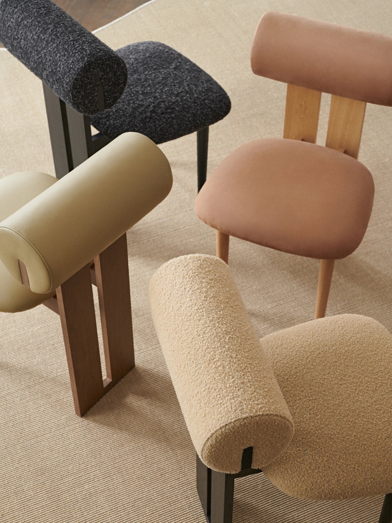 NORR11 Hippo Chair, a collection of organic modern dining and accent chairs featuring a distinctive cylindrical backrest and rounded, plush seats.