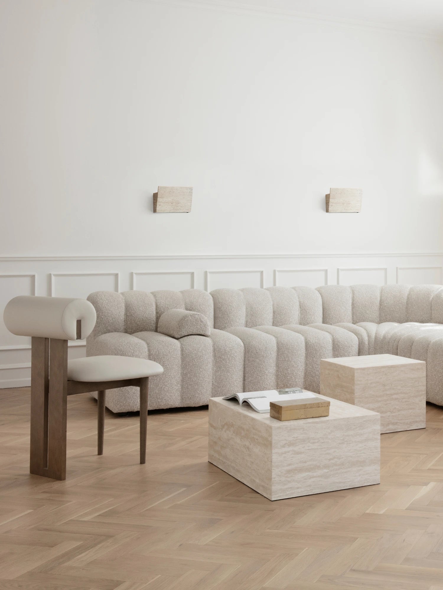 NORR11 Hippo Chair, a striking modern sculptural chair featuring a robust natural ash solid wood frame and a distinctive cylindrical backrest with a cut-out, upholstered in smooth light beige leather. This contemporary dining chair or living room accent piece boasts minimalist lines and organic curves, perfect for sophisticated interiors seeking designer furniture.