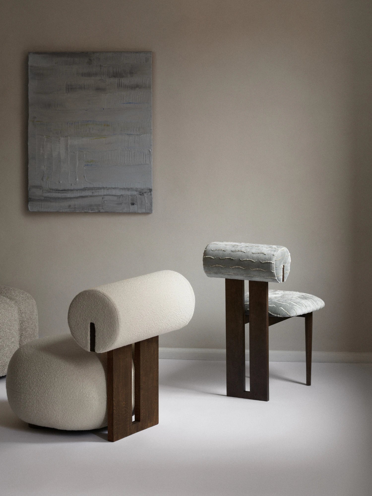 NORR11 Hippo Chair, an organic modern sculptural chair featuring a distinctive cylindrical backrest and a robust dark wood frame with a brutalist-inspired plank design.