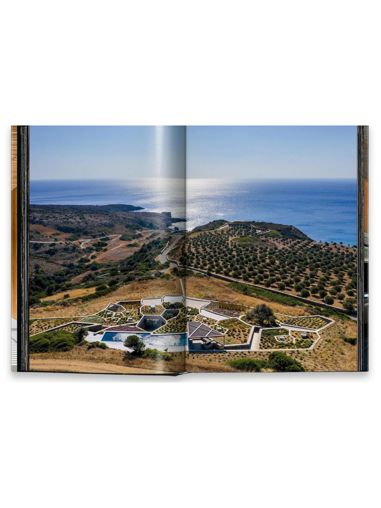 Book Homes for Our Time. Vol. 2, featuring a stunning aerial photograph of a modern residential complex with multiple pools and geometric landscaping overlooking a sparkling blue ocean and olive groves. This premium architecture book is perfect for design enthusiasts and professionals seeking inspiration from unique contemporary homes.