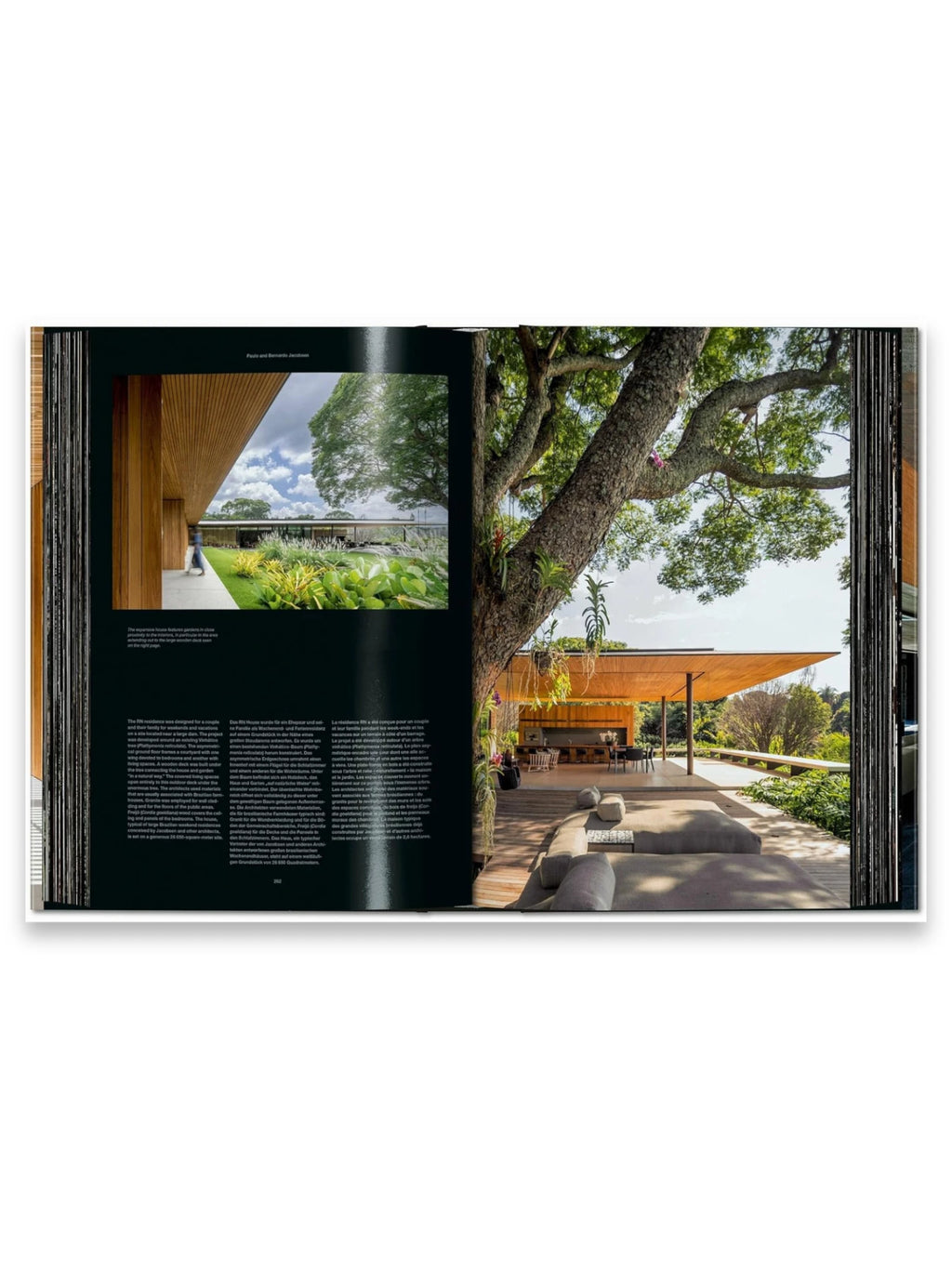 Book Homes for Our Time. Vol. 2, an open architectural design book showcasing a modern, spacious home with a large wooden deck and natural landscaping. This premium volume is perfect for architecture enthusiasts and interior design professionals seeking inspiration.