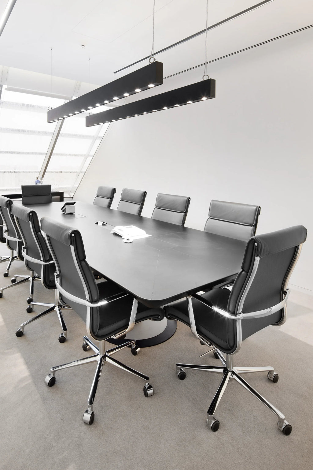 ICF Una Executive Office Chair, a sleek modern executive office chair featuring plush black leather upholstery, ergonomic design, and a striking polished chrome frame and five-star base with smooth-rolling casters. Ideal for contemporary executive offices, professional conference rooms, and stylish boardrooms.