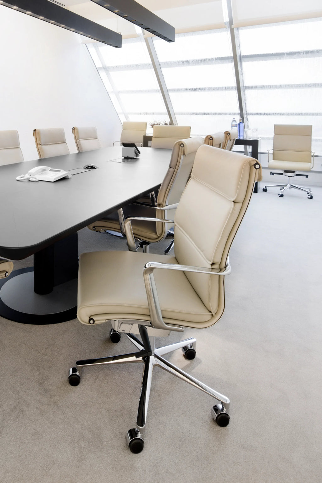 ICF Una Executive Office Chair, a sleek modern executive chair featuring plush cream leather upholstery with distinctive horizontal ribbing and a high-back design, supported by a polished chrome five-star base with smooth-rolling casters and curved metal armrests. Ideal as a luxurious and ergonomic office chair for contemporary conference rooms, boardrooms, or executive office spaces.