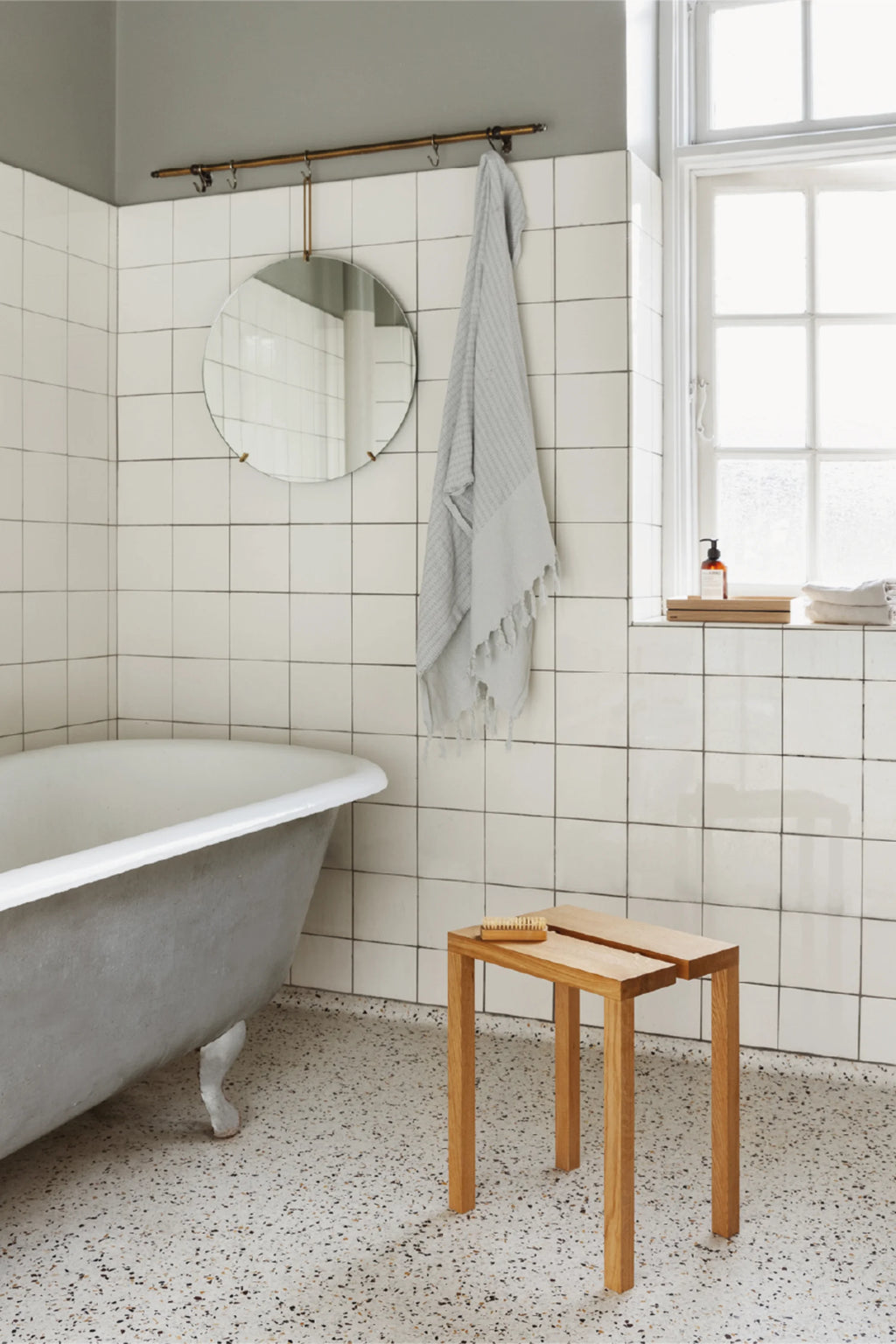MOEBE Peg Stool, a modern minimalist stool crafted from natural solid oak wood with a light finish. It features a simple, rectangular top made of two distinct wooden slats and four sturdy, straight legs, embodying clean Scandinavian design. This versatile wooden stool is ideal as a stylish bath stool, shower bench, or accent side table for organic modern and Japandi interiors.