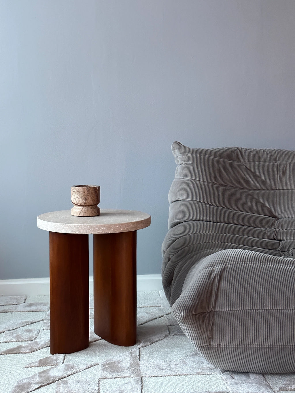 Tinted Objects Dahl Bowl, a unique natural stone decorative bowl with a light brown and beige marbled pattern and a distinct hourglass shape. This elegant, modern accent piece is perfect for adding a touch of sophisticated decor to any stylish home.