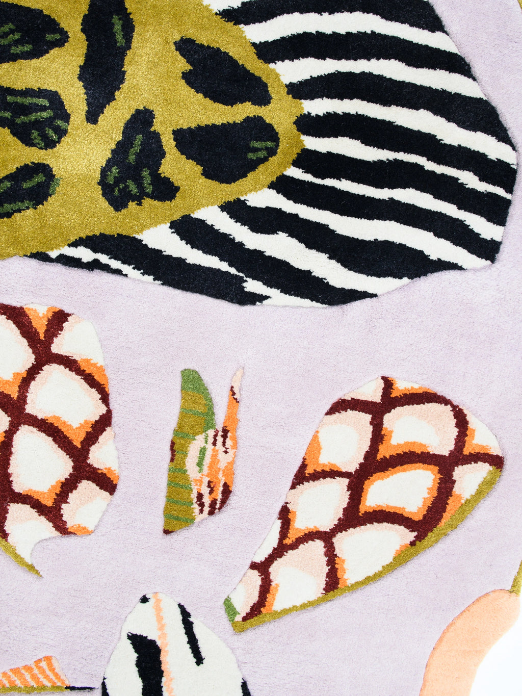 Haus Üger Insecta Rug, a vibrant maximalist tufted wool area rug showcasing an eclectic, multi-color abstract design with organic shapes reminiscent of insect wings and animal prints. It features a plush lilac background accented with bold patterns in olive green, mustard yellow, black, white, terracotta orange, and burgundy. This playful contemporary rug is perfect for adding a statement piece to a modern living room, creative bedroom, or eclectic entryway.