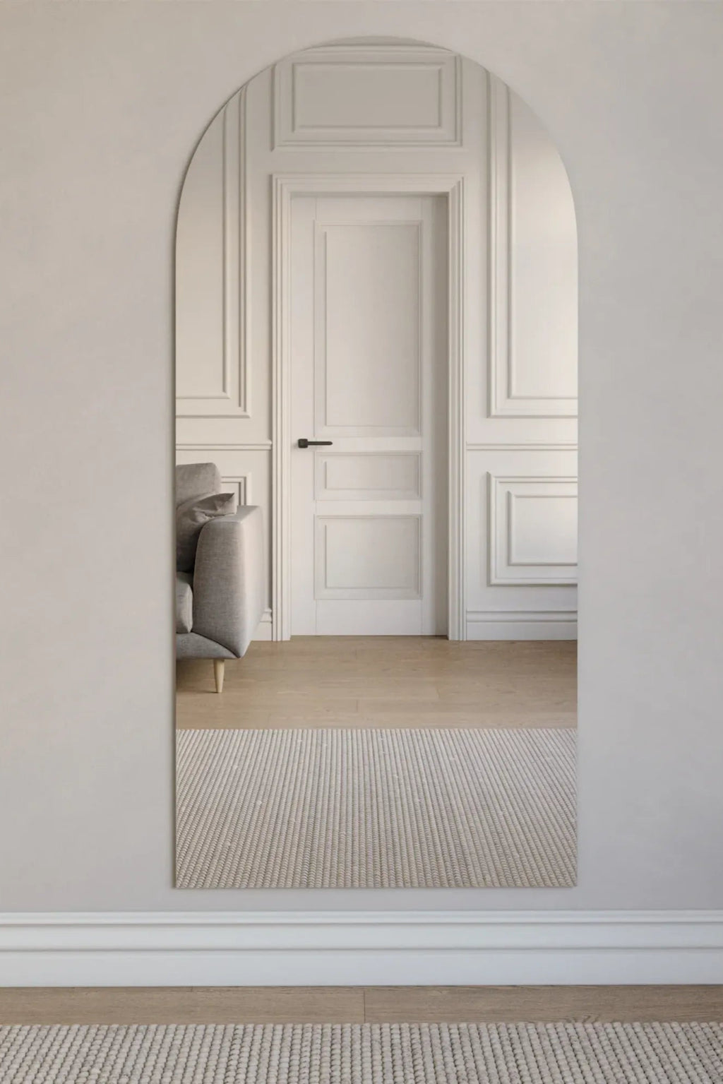 TCL Studios Arc Full Length Mirror, a sleek frameless full-length mirror featuring a clean arched top and straight sides, offering a modern minimalist aesthetic with its seamless reflective surface. This contemporary arched mirror is perfect for adding light and depth to a bedroom, living room, or entryway in organic modern and minimalist interiors.