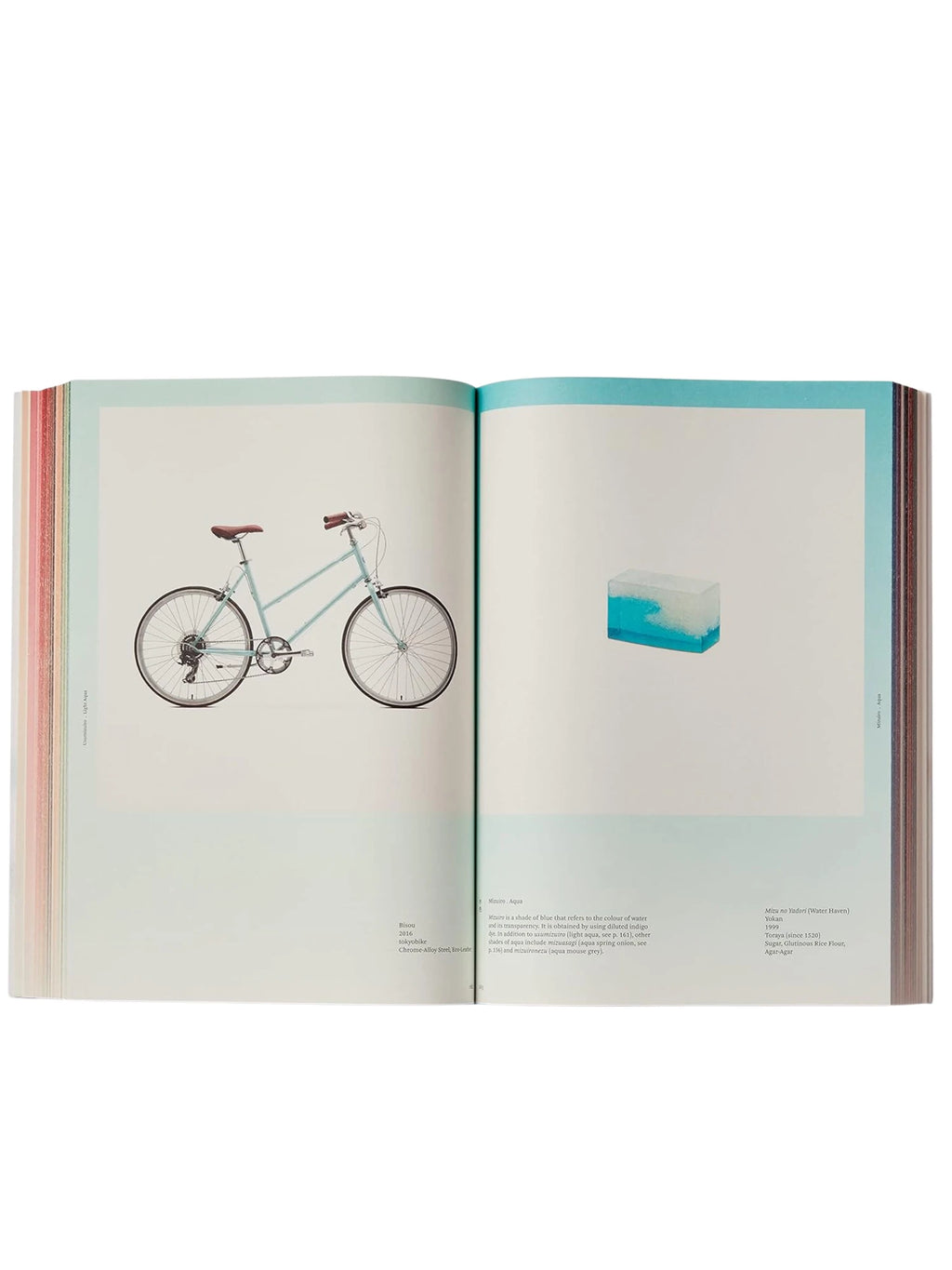 Book Iro - The Essence of Color in Japanese Design, an open hardcover book showcasing an elegant light blue bicycle on the left page and a unique clear and blue rectangular art piece on the right. This aesthetic design book is perfect for art enthusiasts, designers, and anyone interested in Japanese culture and color theory.