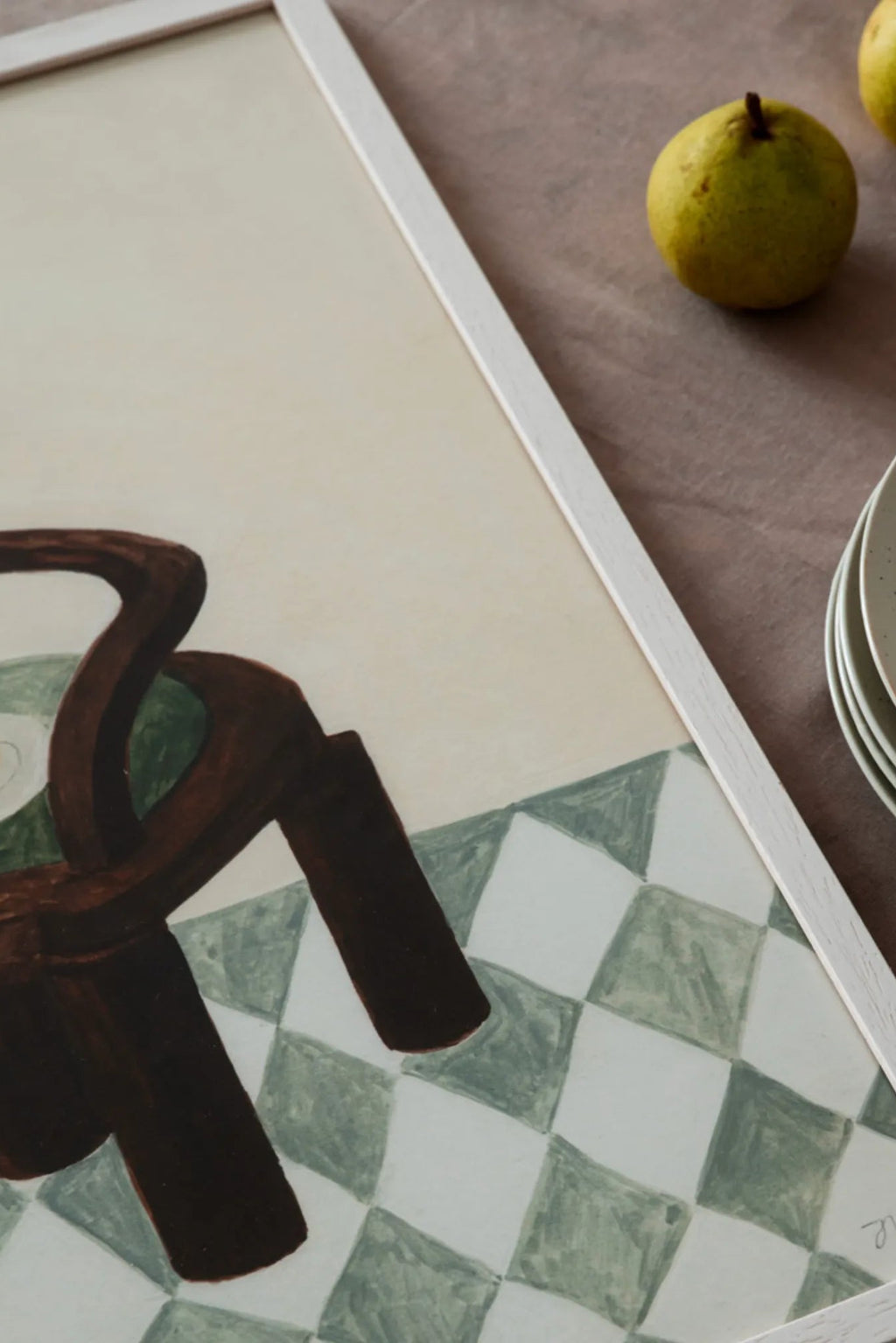 Modern wooden chair with colorful cushions and a bowl of fresh fruit on the armrest