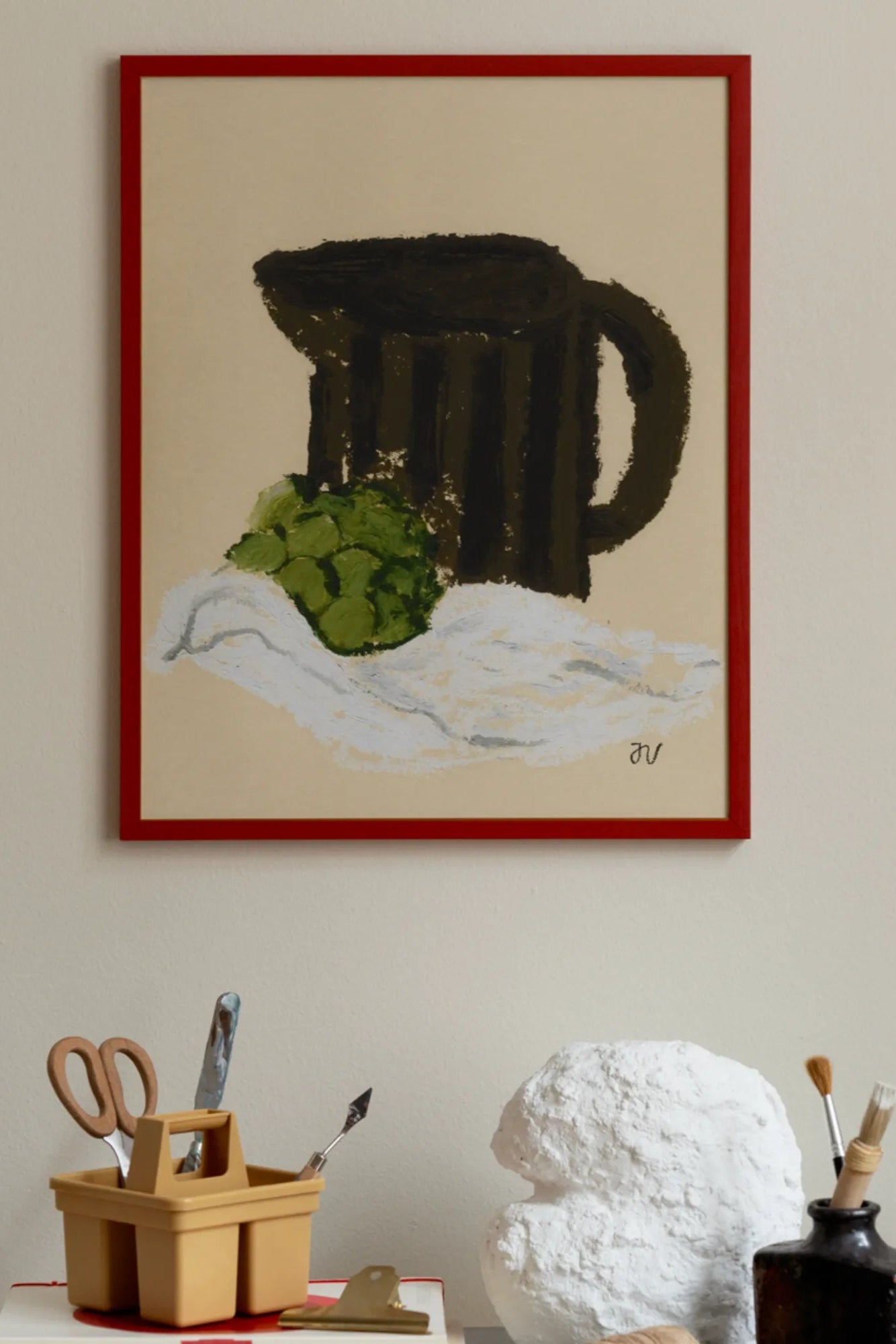 Colorful artichoke and floral arrangement in a rustic vase on a table