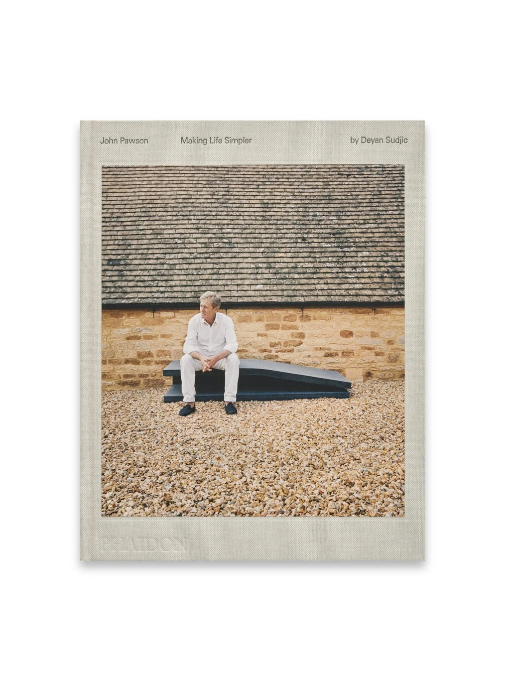 Book John Pawson - Making Life Simpler, a hardcover design book with a light beige linen cover and a photographic inset featuring John Pawson seated on a black bench against a stone building and gravel. This insightful book is perfect for minimalist architecture and design enthusiasts seeking inspiration for a simpler lifestyle.