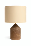 Table lamp with a beige shade and brown alabaster base on a white background