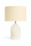 Table lamp with a beige shade and white base on a white background