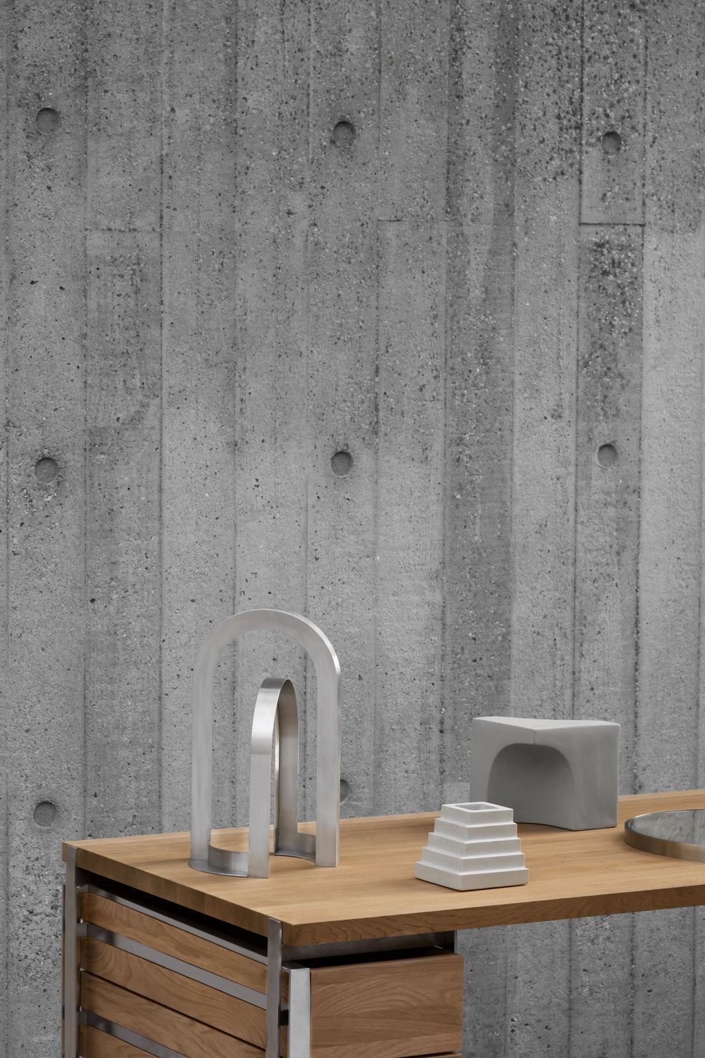Kristina Dam Arch Sculpture, a striking modern minimalist decorative object crafted from brushed stainless steel, featuring two interlocking silver arch shapes with a smooth, matte finish. This geometric metal sculpture embodies contemporary Scandinavian design, perfect for brutalist-inspired shelf styling, home office decor, or as a sophisticated living room accent.