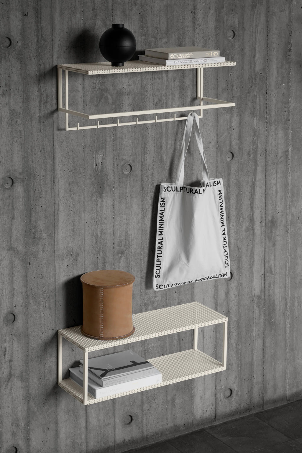 Kristina Dam Stitched Leather Box, a cylindrical tan leather storage box with a flat removable lid and contrasting white hand-stitched detailing, showcasing a minimalist Scandinavian design. This round decorative leather box is perfect for modern shelf styling, home office organization, or as a sophisticated accent piece in contemporary living spaces.