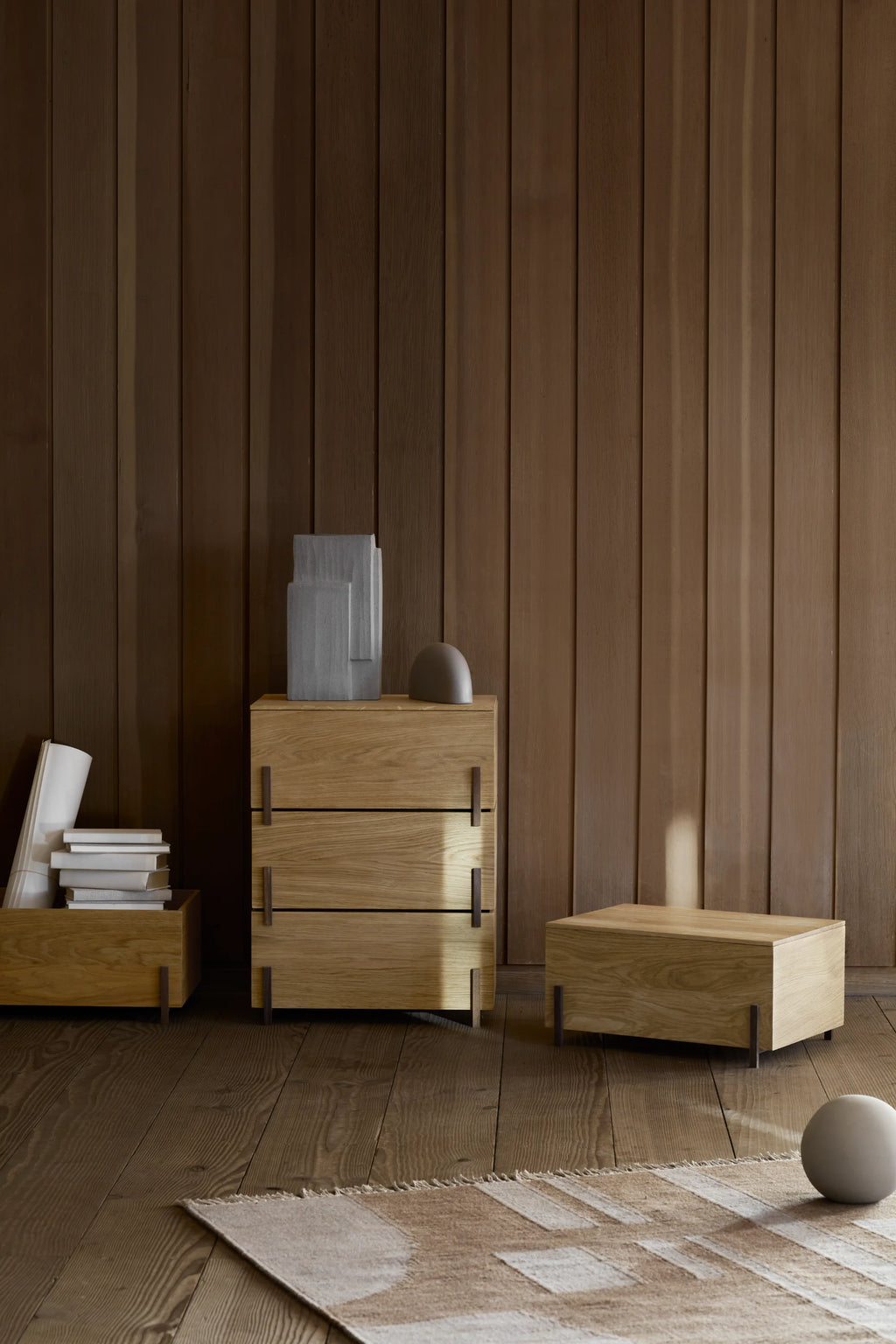 Kristina Dam Stack Storage Box - Set of 3, a collection of modern minimalist storage units crafted from natural solid oak wood with clean lines and distinctive dark metal feet/handles.