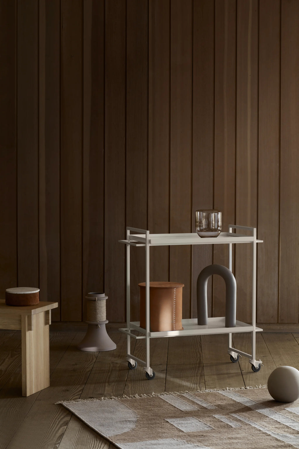 Kristina Dam Stitched Leather Box, a cylindrical modern minimalist storage box crafted from rich tan leather with distinctive vertical white stitching and a contrasting light-toned lid. This Scandinavian design accent provides stylish decorative storage for living rooms, bedrooms, or contemporary shelf styling.