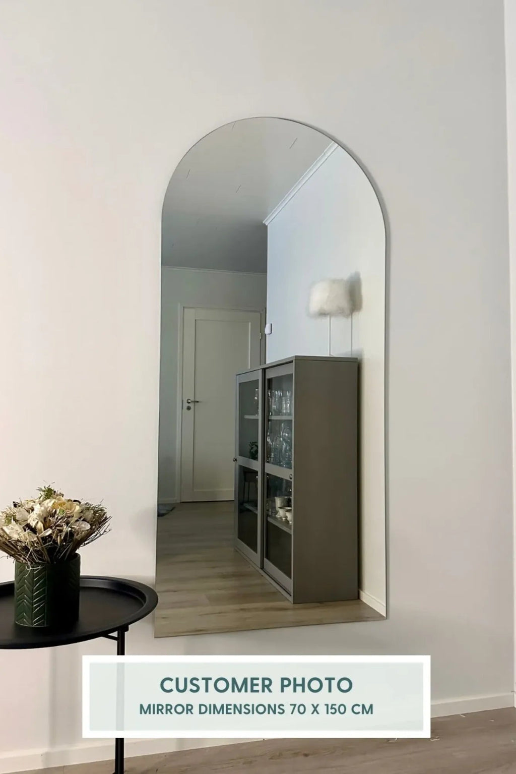 TCL Studios Arc Full Length Mirror, a modern minimalist frameless arched mirror featuring a sleek, clean design and expansive reflective silver surface with dimensions of 70x150cm. This contemporary full length mirror offers an elegant, organic silhouette, perfect as a floor mirror or wall-mounted accent. Ideal for enhancing light and space in a chic bedroom, stylish entryway, or modern dressing room.