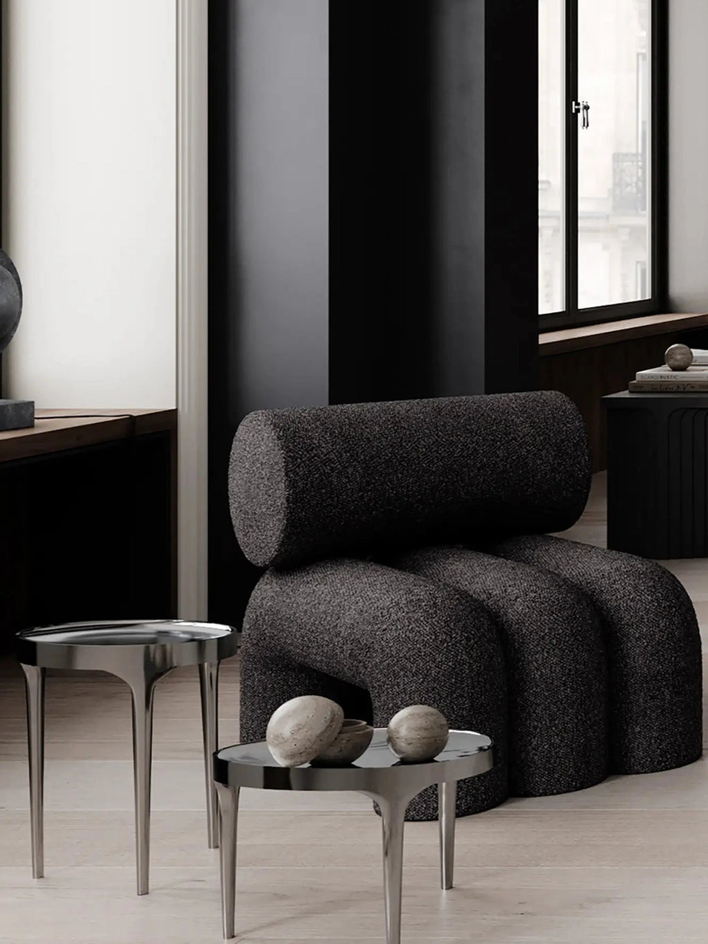 101 CPH Foku Lounge Chair in a moody, minimalistic living room. This premium, dark charcoal boucle fabric lounge chair features a unique curved, multi-lobed base and a cylindrical backrest. Ideal for modern interior designs.