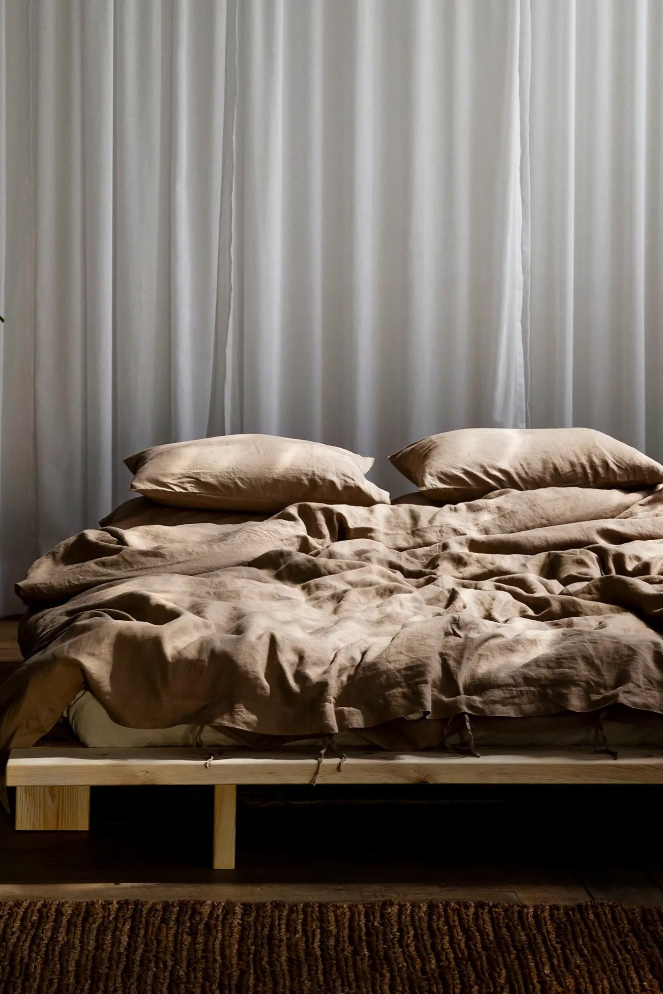 Handcrafted solid wood platform bed with minimalist design and clean lines, inspired by traditional Japanese architecture, in its natural state without any finish or staining, perfect for creating a peaceful and calming atmosphere in any bedroom