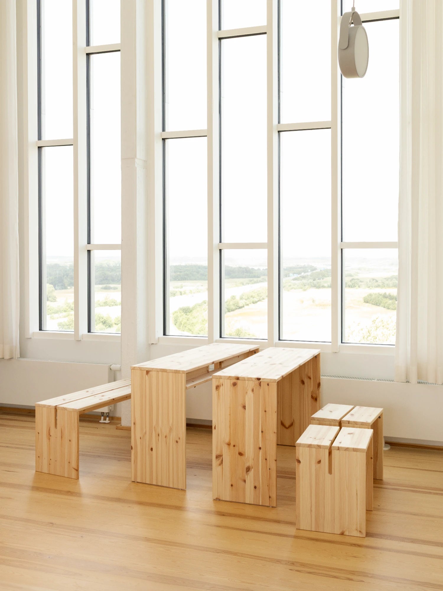join-in dining table karup design in a room with big windows that bring alot of natural light