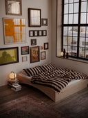 the orbit bed karup design in a loft style minimalistic apartment with artprints on the wall