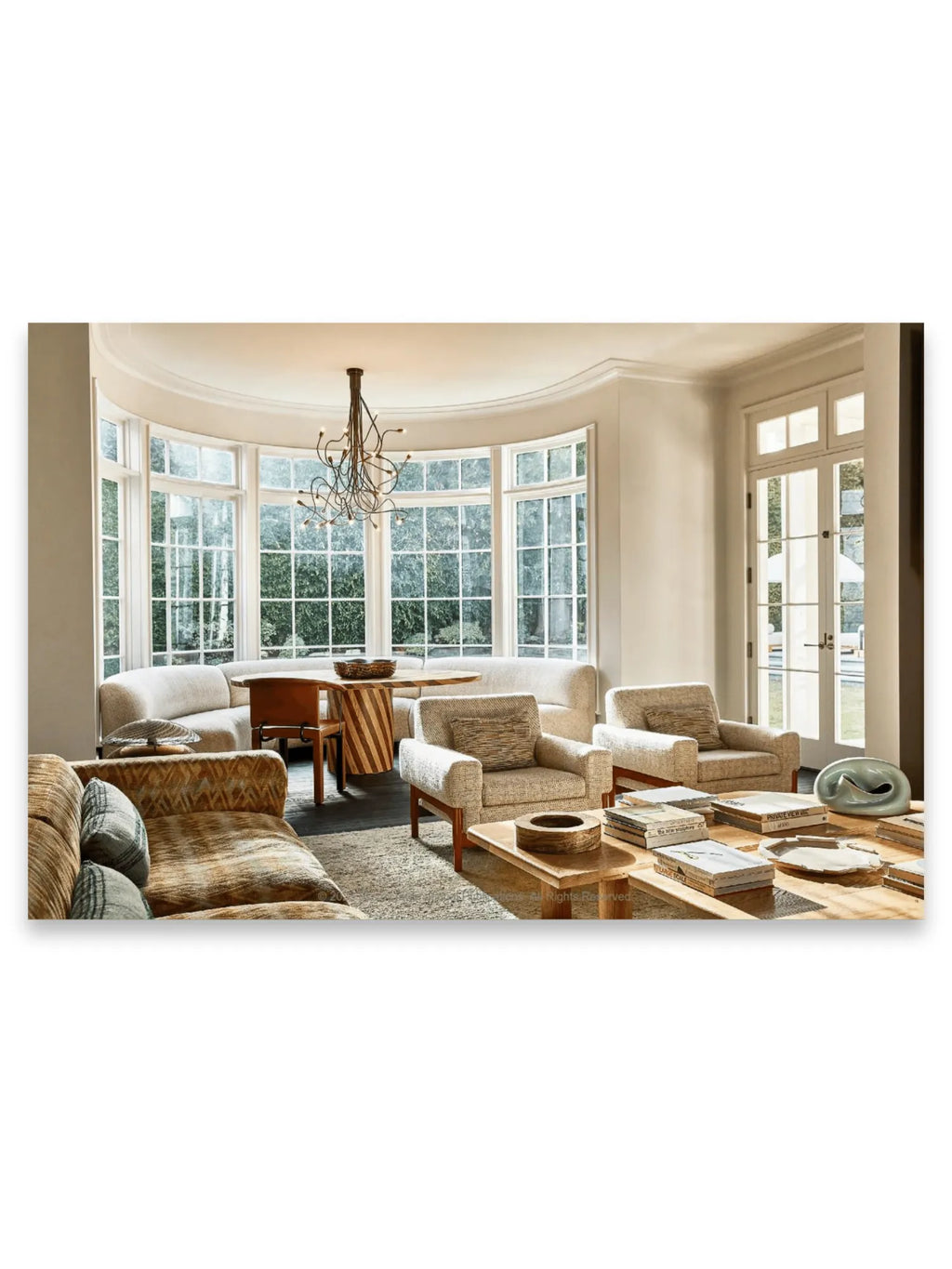 Kelly Wearstler - Synchronicity, a hardcover interior design book displayed on a light wood coffee table amidst other stylish decor in a luxurious, modern living room. This inspiring art book is perfect for interior design enthusiasts, architects, and home decor lovers seeking creative inspiration.