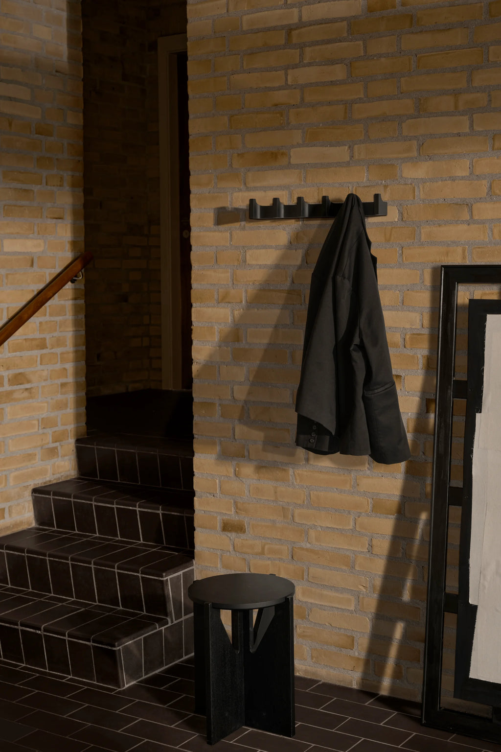 Kristina Dam Long Column Coat Rack, a modern minimalist wall hanger crafted from matte black powder-coated steel, featuring a linear design with multiple geometric, folded column-like hooks. Its sleek, contemporary aesthetic provides functional storage while adding sculptural interest to any space. Perfect for a stylish entryway, modern hallway, or Scandinavian mudroom.