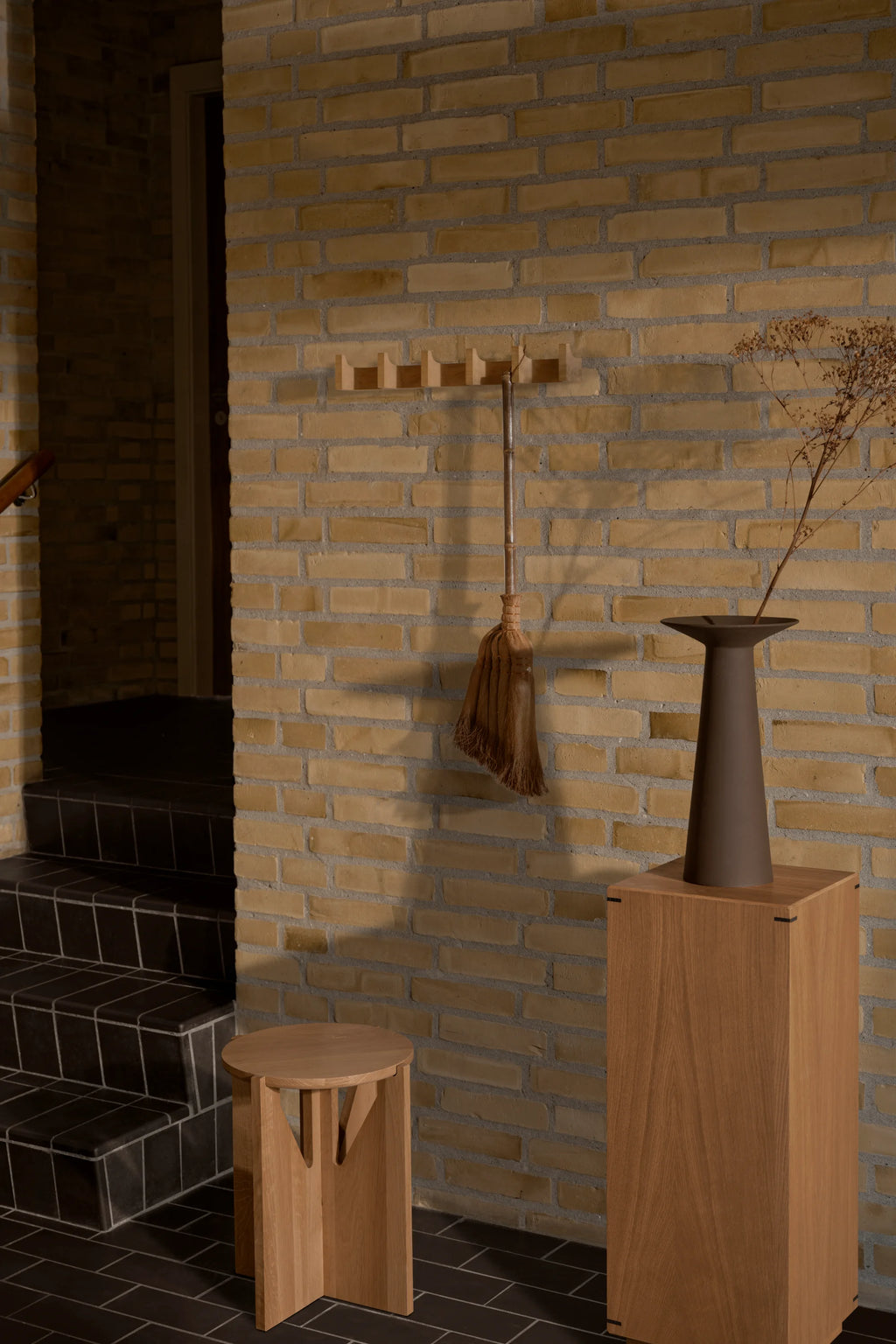 Kristina Dam Long Column Coat Rack, a modern minimalist wall hanger crafted from natural light solid oak wood, featuring five geometric column-like pegs for coats and accessories. This Scandinavian-inspired oak coat rack is perfect for stylish entryway storage or a contemporary hallway.