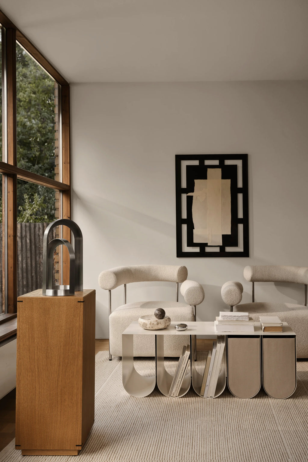Kristina Dam Arch Sculpture, a modern minimalist sculpture crafted from dark brushed stainless steel, featuring two nested geometric arch shapes with a clean, architectural design. This contemporary art object is perfect for sophisticated shelf styling or as a striking decorative accent in a living room or home office.