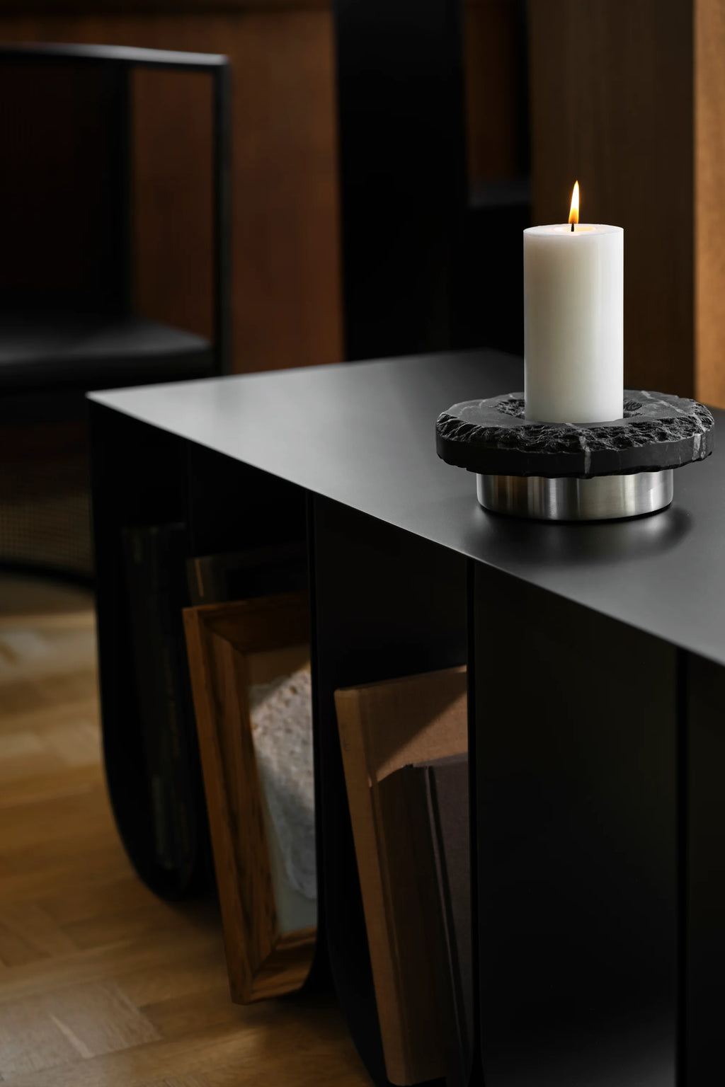 Kristina Dam Curved Bench, a sleek modern minimalist bench crafted from matte black steel with a gently curved silhouette and open storage compartments. This versatile black metal console table is perfect for Scandinavian living rooms, contemporary entryways, or as a stylish display shelf in design-conscious interiors.