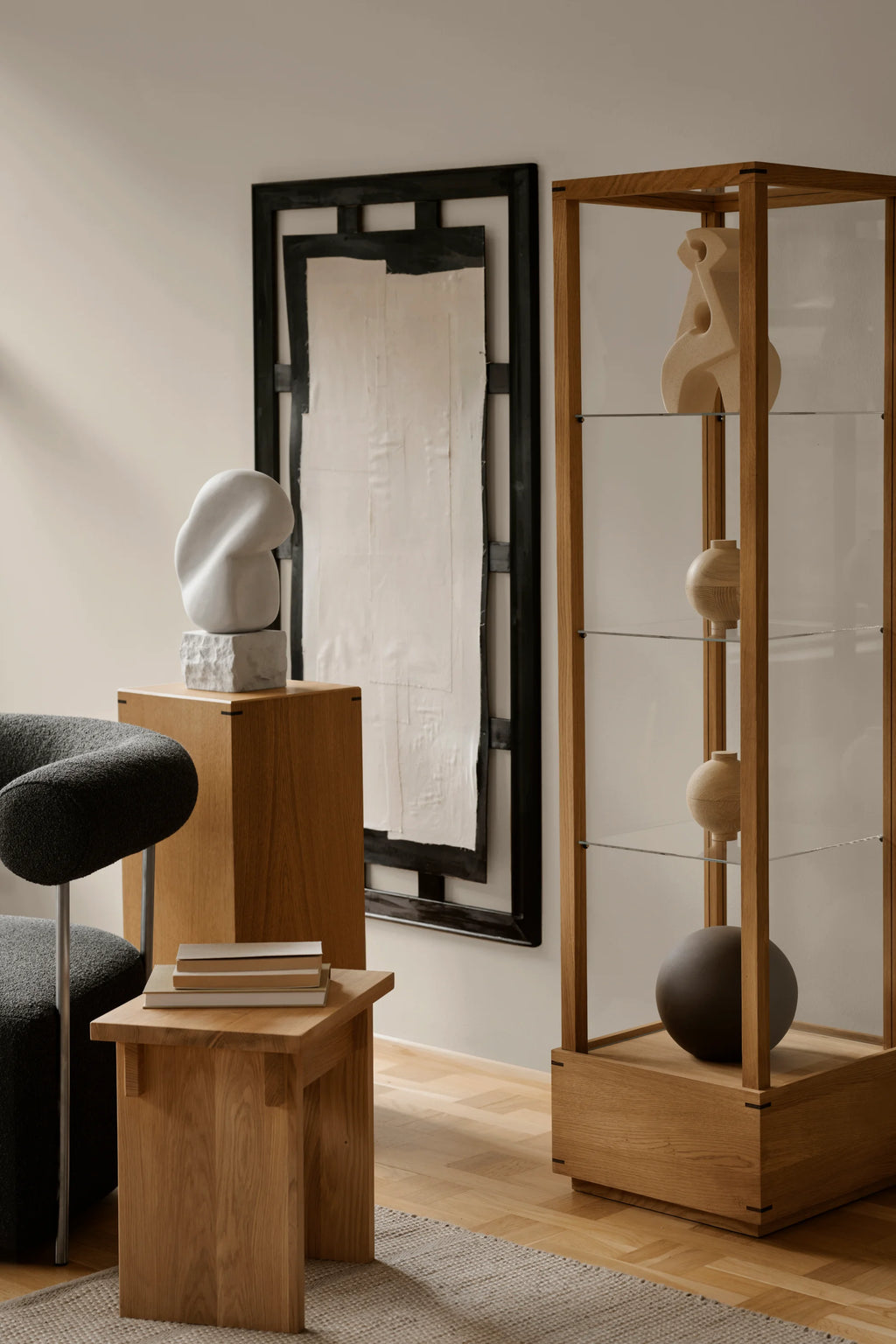 Kristina Dam Artisan Stool, a minimalist solid oak stool featuring a sturdy, block-like design with a natural light wood finish and subtle wood grain. This versatile piece functions as a contemporary side table or a unique display pedestal. Ideal for Scandinavian living rooms, modern bedrooms, or elegant entryway decor.