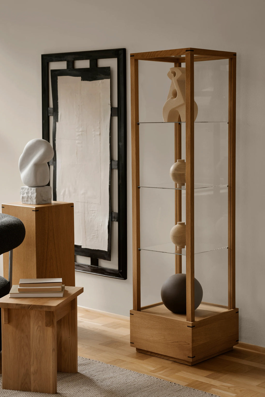 Kristina Dam Japanese Cabinet M, a tall, minimalist display cabinet crafted from natural solid oak with clear glass sides and shelves, featuring elegant dark joint details. This Scandinavian and Japanese-inspired oak showcase provides refined storage for collectibles, ideal for modern minimalist living rooms, dining rooms, or home office spaces.
