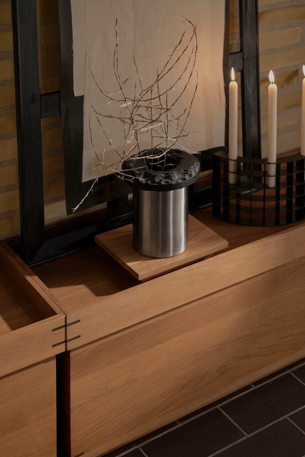 Kristina Dam Capital Podium, a modern minimalist decorative tray featuring a warm natural solid oak wood base with a contrasting dark, rough-edged volcanic stone top.