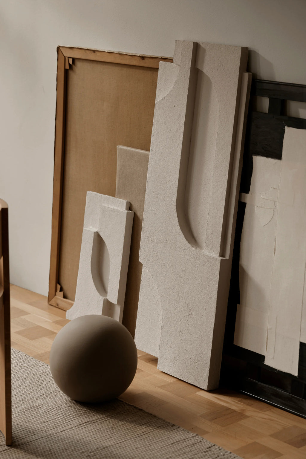 Kristina Dam Serif Relief S, an off-white textured concrete wall relief featuring abstract organic and geometric shapes carved into its surface, creating a sculptural art piece with a brutalist-inspired yet minimalist aesthetic.