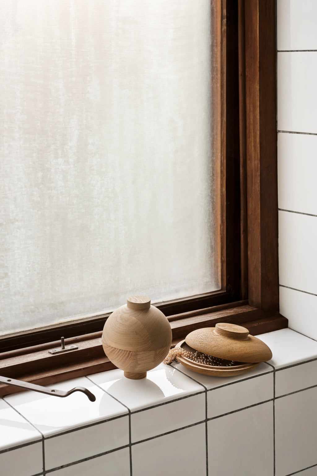 Kristina Dam Wooden Galaxy, a set of two natural light wood decorative storage boxes, featuring smooth, minimalist spherical and rounded forms with visible wood grain. One is an orb-shaped storage box with a flat top lid, and the other is a shallow rounded bowl with a coordinating lid, ideal for discreetly storing small treasures or jewelry. Perfect for Scandinavian or organic modern shelf styling, bedroom accents, or entryway organization.