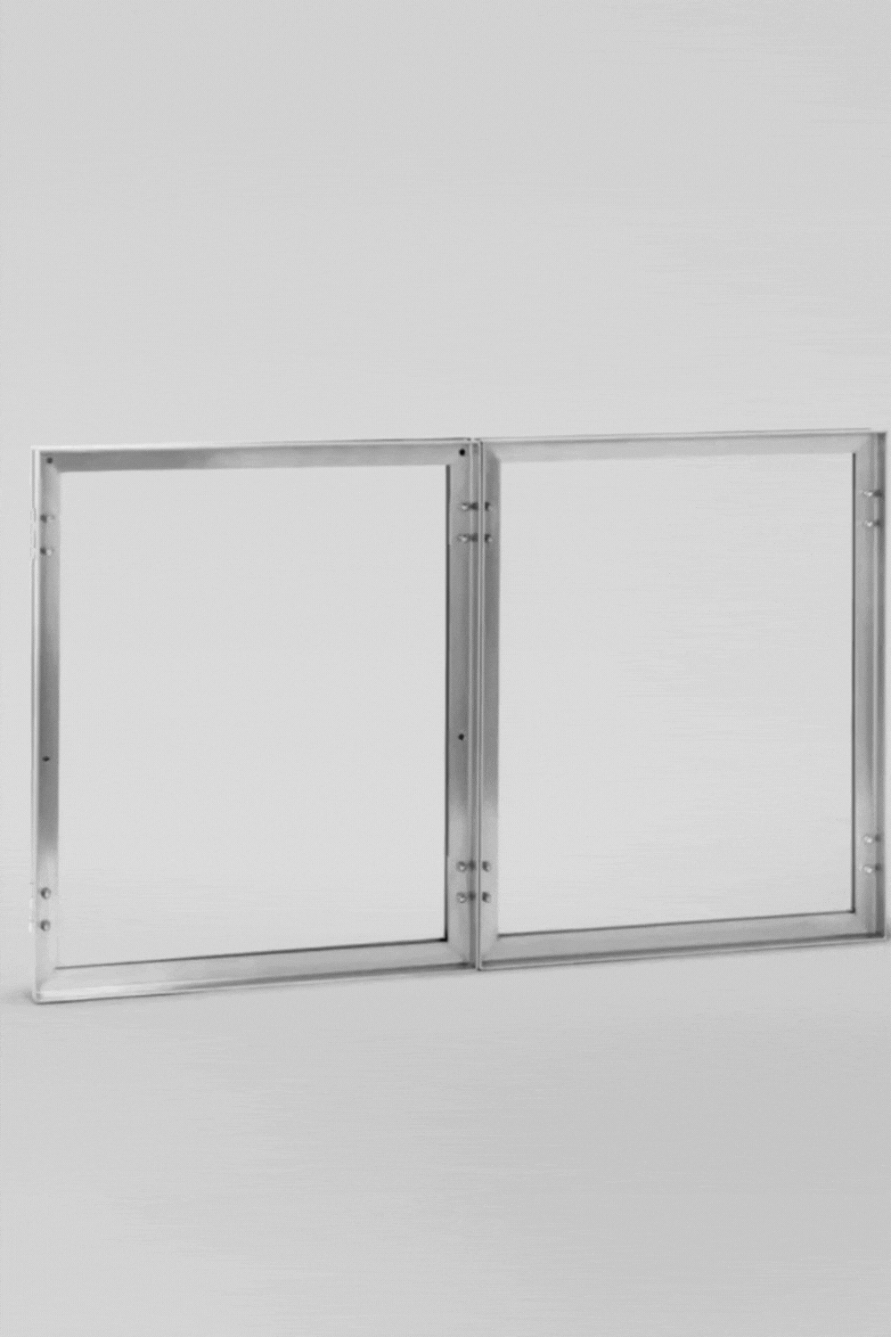 Kristina Dam Foldable Side Table, a sleek modern minimalist folding table crafted from brushed silver metal, featuring two connected square frames with visible industrial-style rivets.