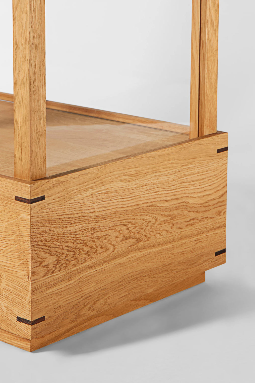 Kristina Dam Japanese Cabinet L, a minimalist storage cabinet crafted from natural solid oak wood with distinctive dark wood joinery details and clean, architectural lines. This contemporary oak display unit features a visible glass shelf and showcases a refined Japanese design aesthetic. Ideal for sophisticated living room storage or modern dining room display.
