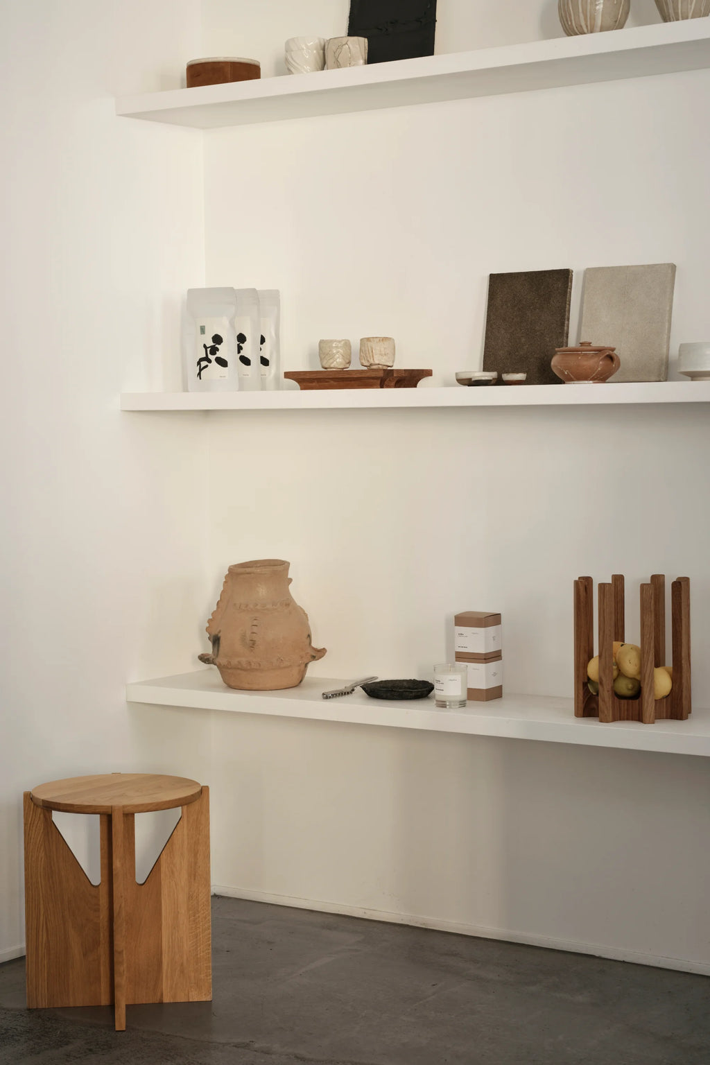 Kristina Dam Capital Podium, a dark brown solid oak decorative tray with a striking architectural design, featuring a sturdy rectangular base with elegant curved cutouts supporting a raised platform. This modern minimalist wood display stand, crafted from smooth, rich dark stained oak, provides an elevated surface for cherished objects. Perfect as a contemporary serving tray or for minimalist shelf styling in Scandinavian or organic modern living spaces.