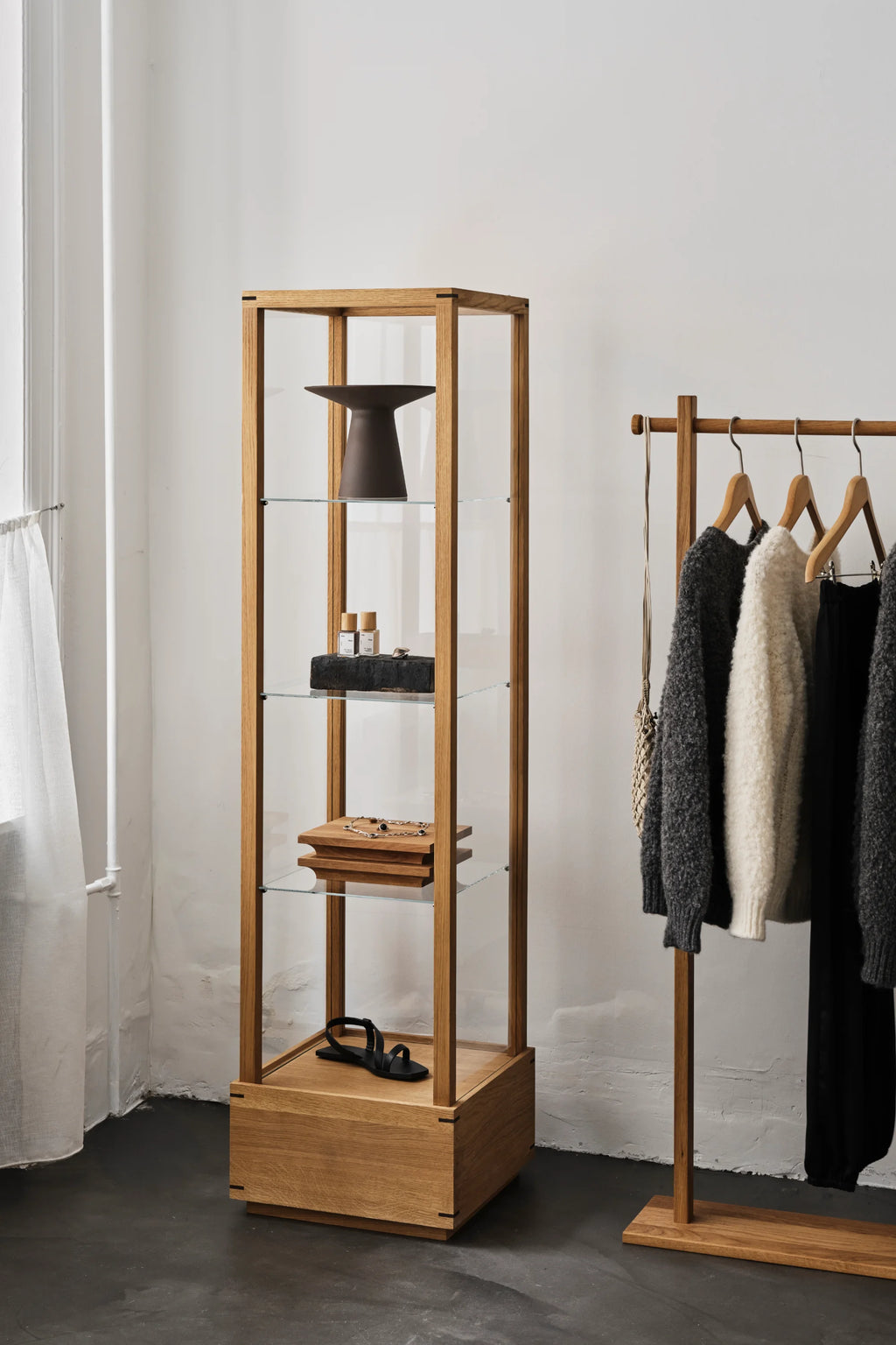 Kristina Dam Japanese Cabinet M, a sleek, modern minimalist display cabinet crafted from natural solid oak wood with clear glass sides and adjustable glass shelves.
