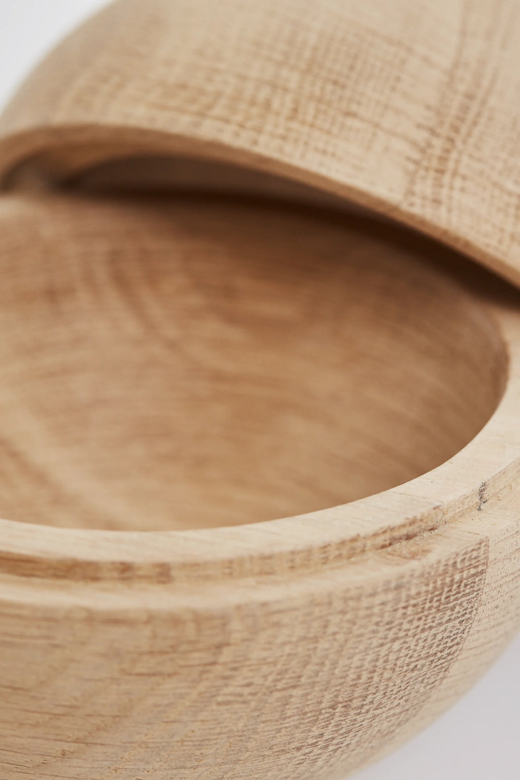 Kristina Dam Wooden Sphere, a natural light solid oak decorative storage object with a smooth finish and visible wood grain, designed as a perfect sphere with a removable lid. This modern minimalist wooden container is ideal for Scandinavian shelf styling or as a bedside table trinket box.