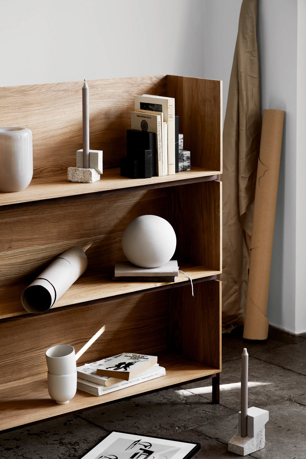 Kristina Dam Offset Candleholder Vol. 1, a sculptural modern minimalist candle holder crafted from two stacked, offset blocks of natural light grey stone, one with a rough, porous texture and the other.